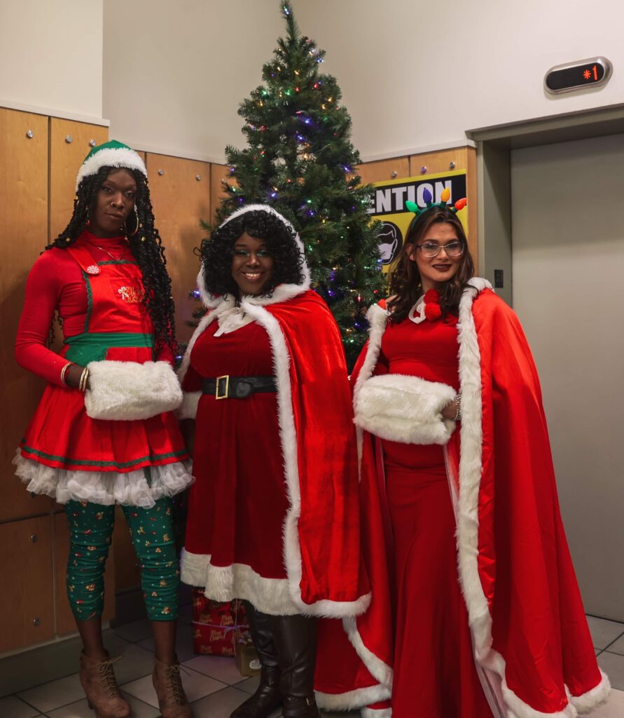 Three People Dressed for the Holidays